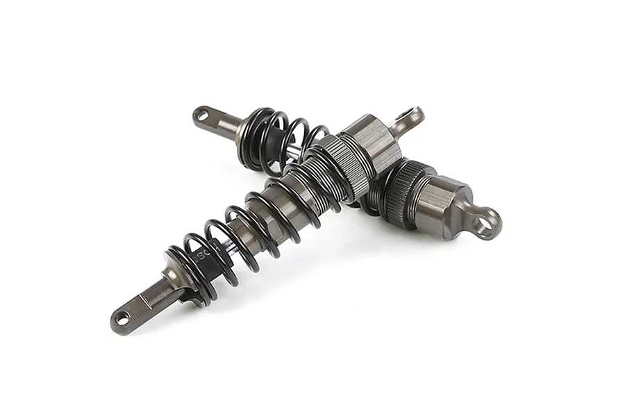 Two gunmetal grey adjustable RC shock absorbers with black springs, shown against a white background.