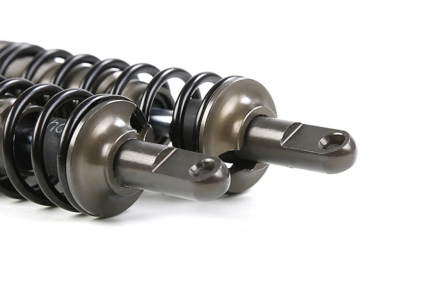 Close-up of two gunmetal-coloured adjustable RC shock absorbers with black springs against a white background.