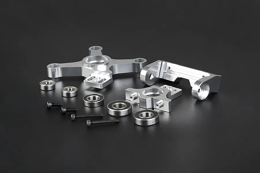 A Rovan complete clutch mount set including silver alloy mounts, metal ball bearings, and black screws arranged on a dark background.