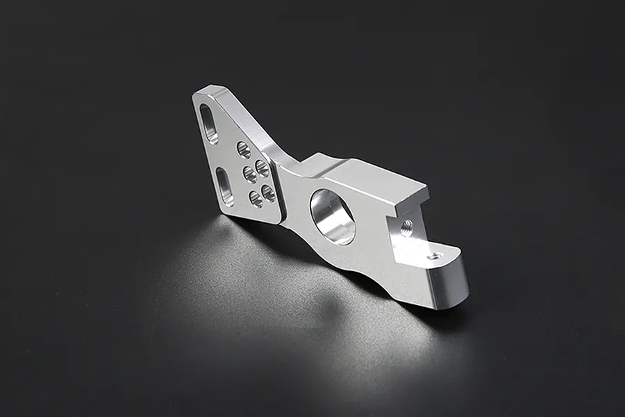A silver Rovan aluminium first stage small gear mount for RC vehicles, shown from an angled perspective against a dark background.