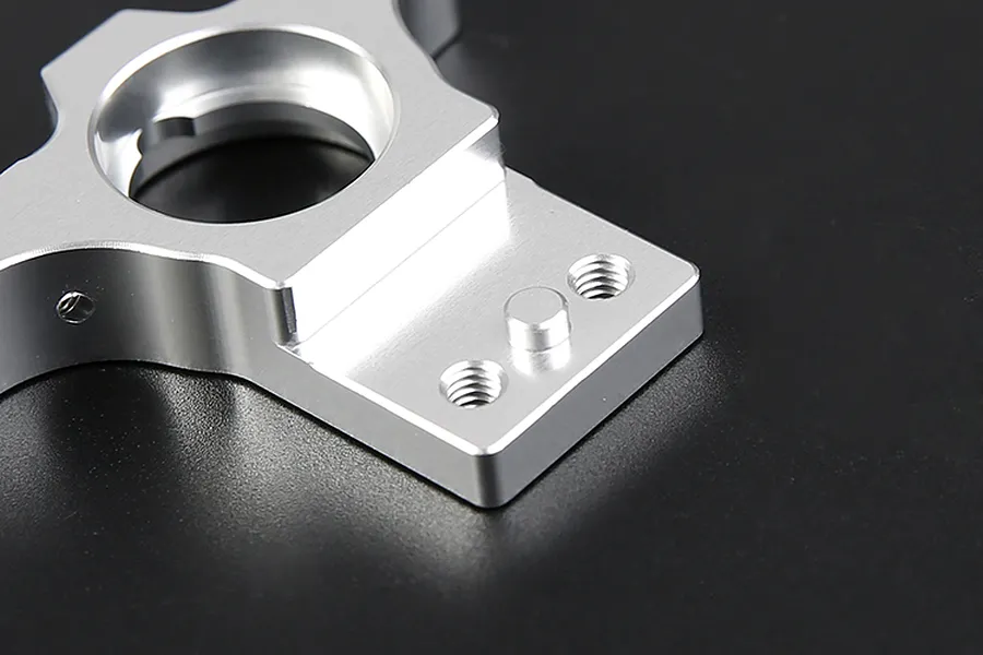 Close-up of a silver Rovan aluminium first stage large gear mount on a black background.