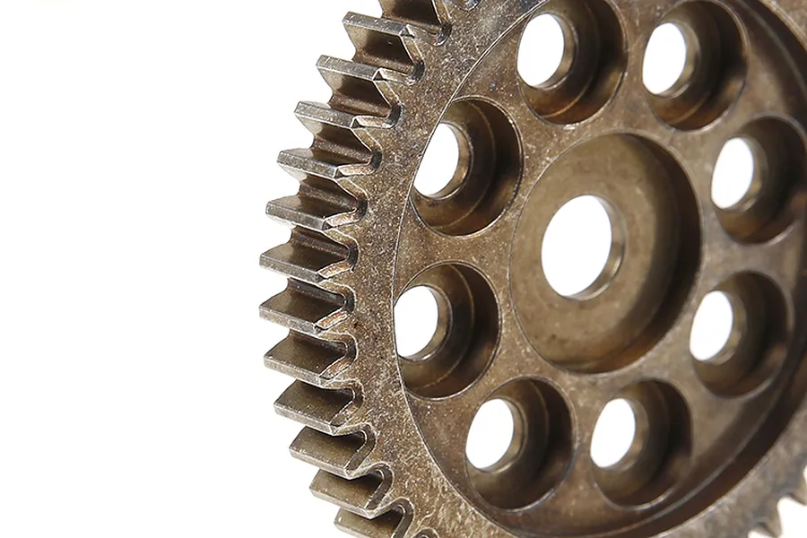 Close-up of a Rovan metal first stage reduction gear showing the teeth and circular cutouts on a white background.