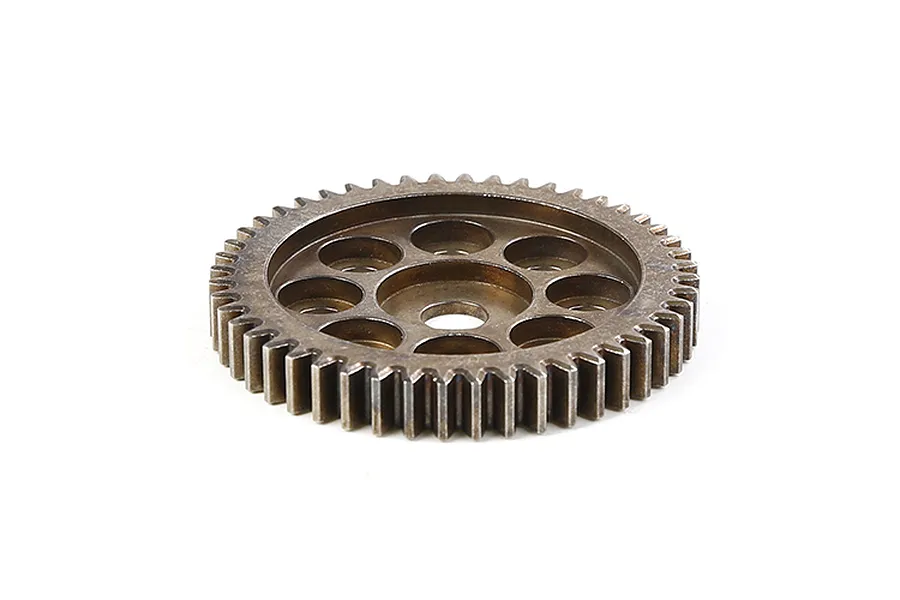A bronze-coloured metal first stage reduction gear for an RC vehicle, featuring a circular design with multiple weight-reduction holes.