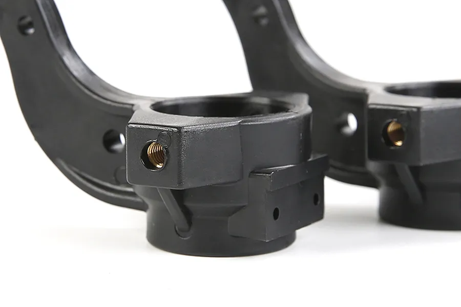 Close-up of two black Rovan RC steering hubs showing mounting points and threaded metal inserts against a white background.