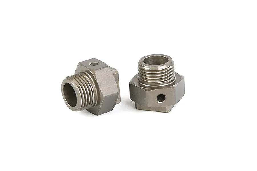 Two gunmetal grey aluminium RC wheel hex adapters with threaded shafts and pin holes, isolated on a white background.