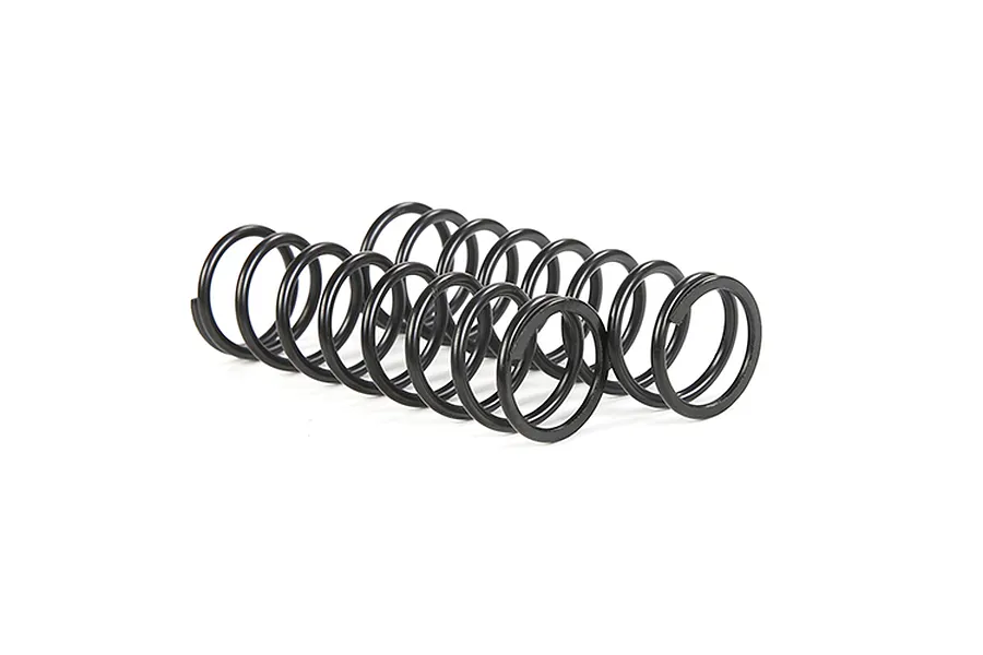 Two black metal coil springs for RC vehicles, positioned side-by-side on a white background.