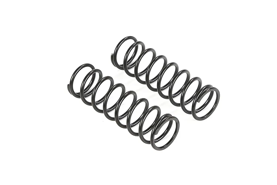 Two black metal coil springs for RC vehicles positioned side-by-side on a white background.