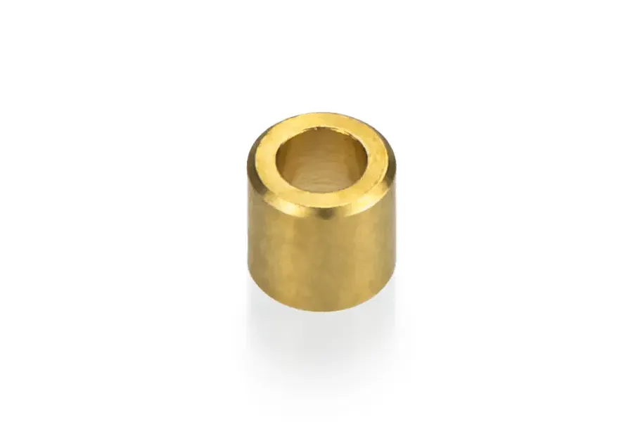 A single small cylindrical copper or brass bushing for RC boat spare parts.