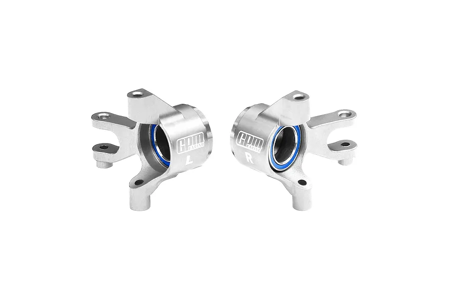A pair of silver GPM Racing aluminium front steering hubs with blue-sealed oversized bearings, marked L and R.