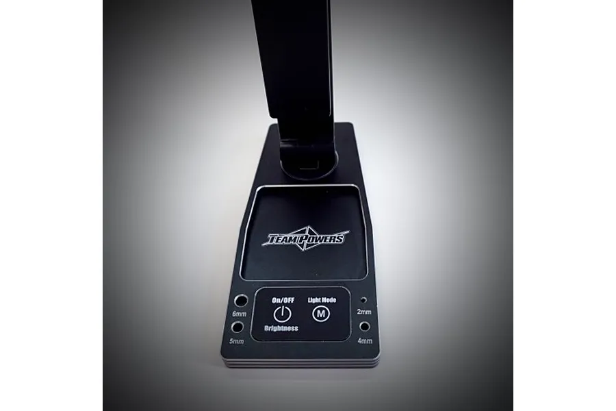 A black Team Powers LED Pit Light Pro base featuring touch controls, a Team Powers logo, and integrated holes for measuring screws.