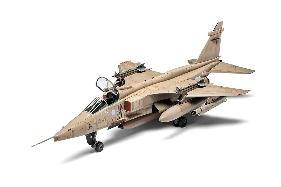 A fully assembled and painted 1/48 scale model of a SEPECAT Jaguar GR.1 fighter jet in a desert camouflage paint scheme.