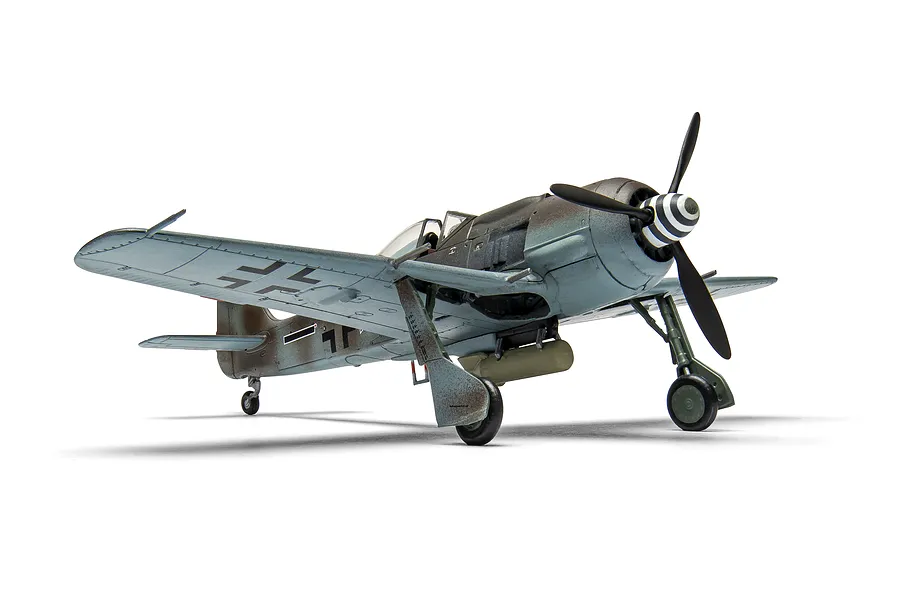 A completed 1/72 scale plastic model of a Focke-Wulf Fw190 fighter aircraft, painted in camouflage with German markings, shown on a white background.