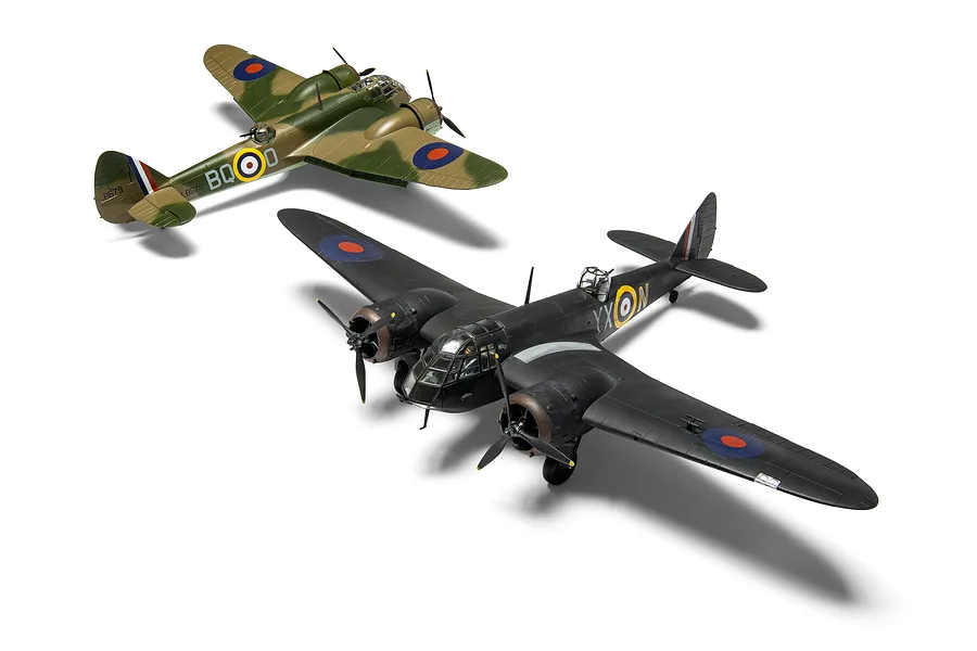 Two assembled and painted 1/72 scale Bristol Blenheim model aircraft, one in green and brown camouflage and one in black night fighter livery.