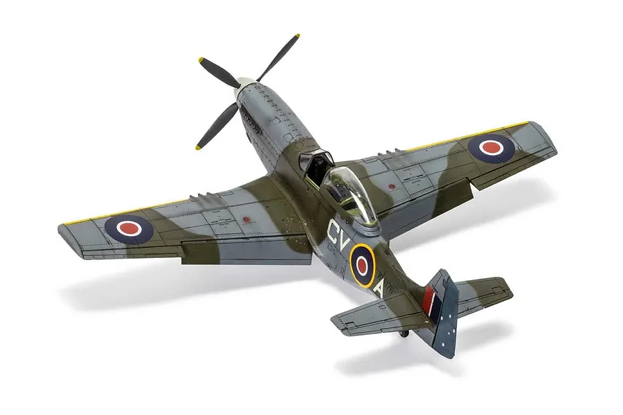 A 1/48 scale plastic model of a North American Mustang Mk.IV fighter aircraft, painted in camouflage with RAF markings, viewed from a high angle.