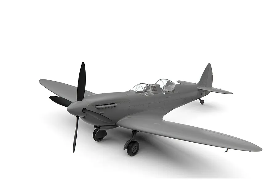 A grey, unpainted plastic model of a Supermarine Spitfire Tr.9 aircraft, showing the dual-cockpit configuration and landing gear.