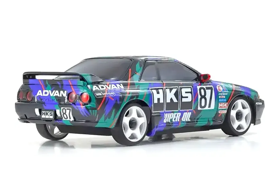 A studio shot of a Kyosho Mini-Z Nissan Skyline GT-R R32 RC car in HKS livery, viewed from the rear three-quarter angle against a white background.