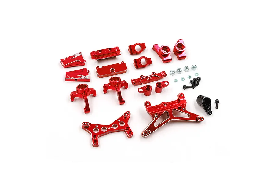 A collection of red anodized aluminium RC car upgrade parts including suspension arms, shock towers, and steering components on a white background.