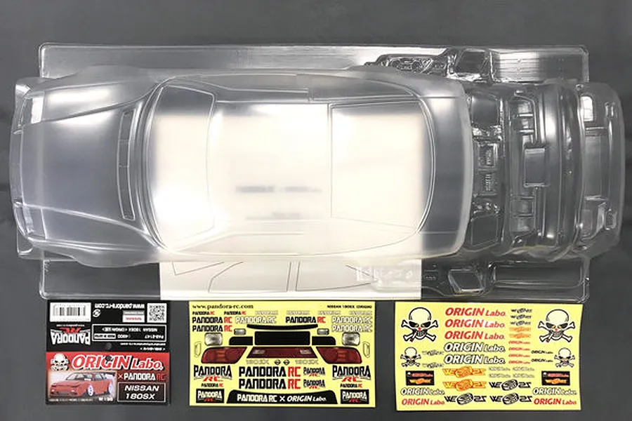 Unpainted clear polycarbonate RC car body shell for a Nissan 180SX by Pandora RC, including decal sheets and header card.
