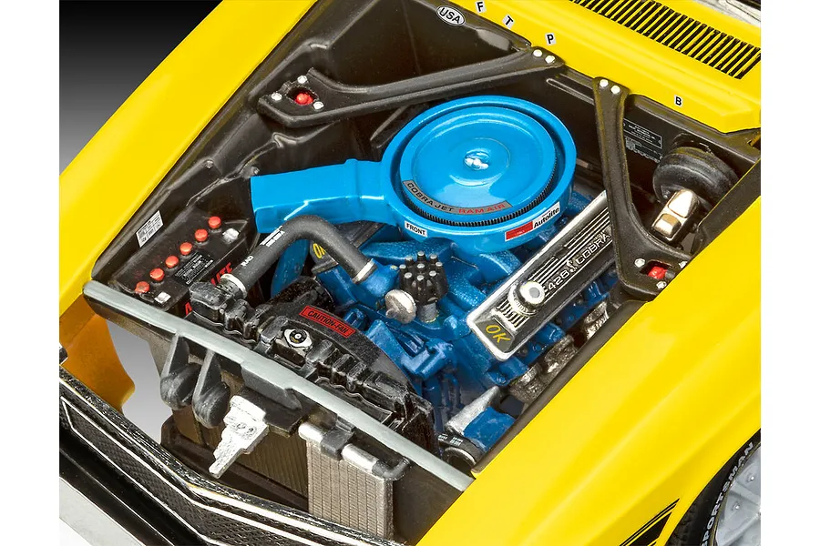 Close-up view of the detailed engine bay of a 1/24 scale Revell 1970 Shelby Mustang GT500 model kit, featuring a blue engine block and air cleaner.
