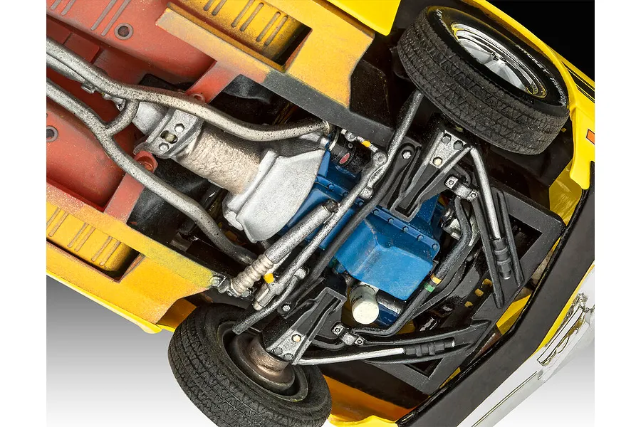 Underside view of a 1/24 scale model car showing the engine, transmission, suspension, and chassis details.