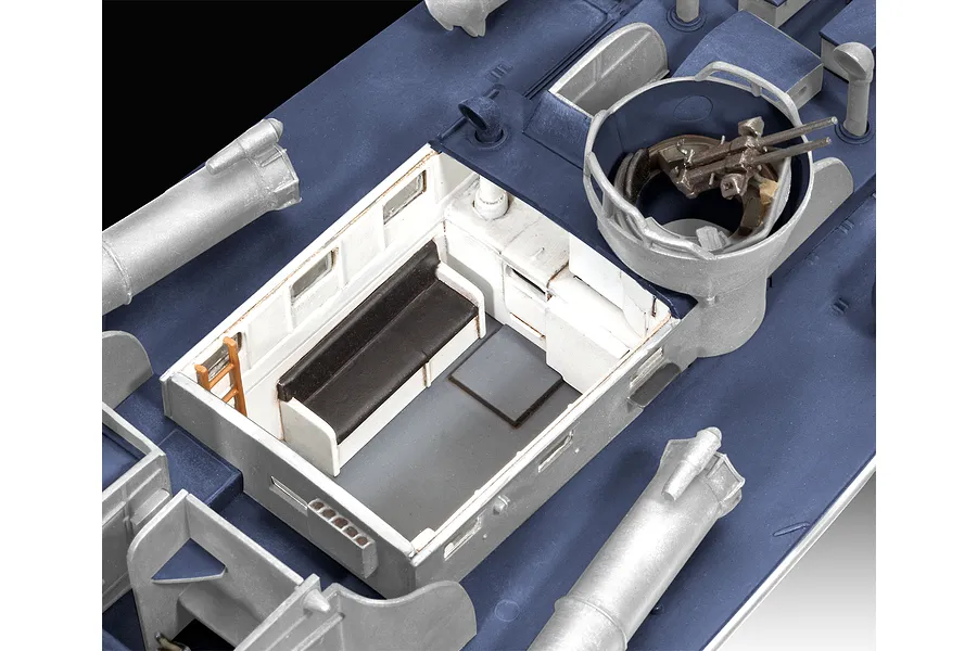 Close-up of a 1/72 scale plastic model PT boat deck showing the interior cabin, bench seating, and a mounted machine gun turret.