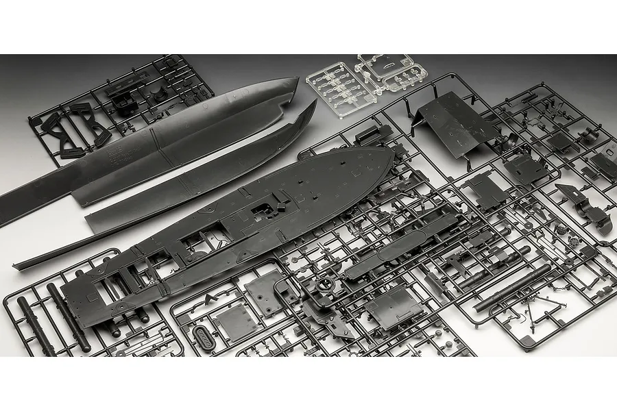 Plastic model kit parts for a 1/72 scale PT boat, including hull sections and various detail sprues on a grey background.