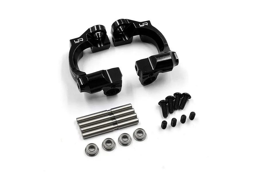 A set of black aluminium C-hub carriers by Yeah Racing, including four metal pins, four small ball bearings, and eight black screws on a white background.