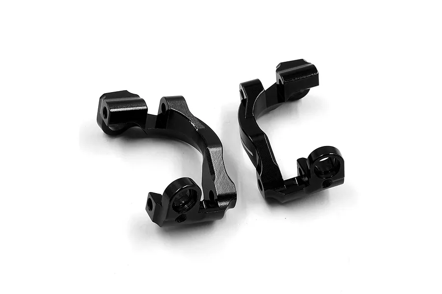 A pair of black anodized aluminium C-hub carriers for RC cars, shown from a high-angle perspective on a white background.