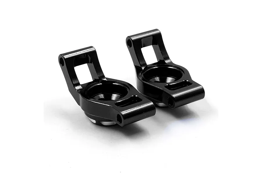 Two black anodized aluminium RC car rear hubs positioned side-by-side against a white background.