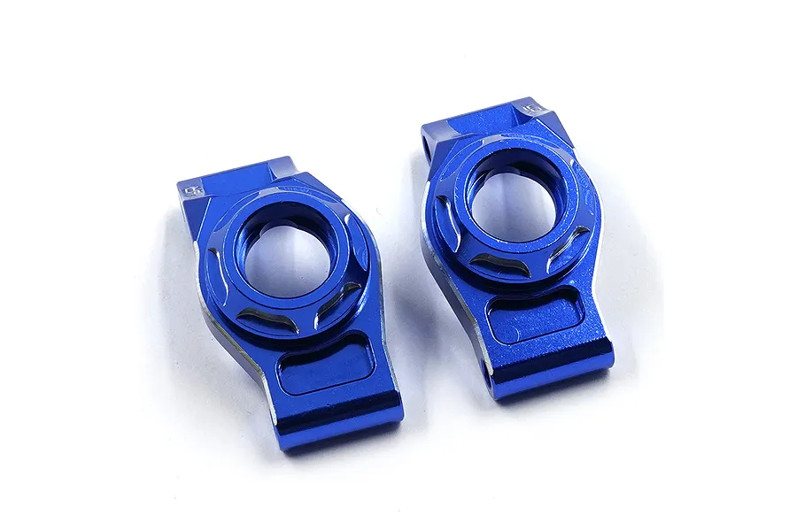 A pair of dark blue anodized aluminium rear hubs for RC cars by Yeah Racing, shown from a top-down perspective on a white background.