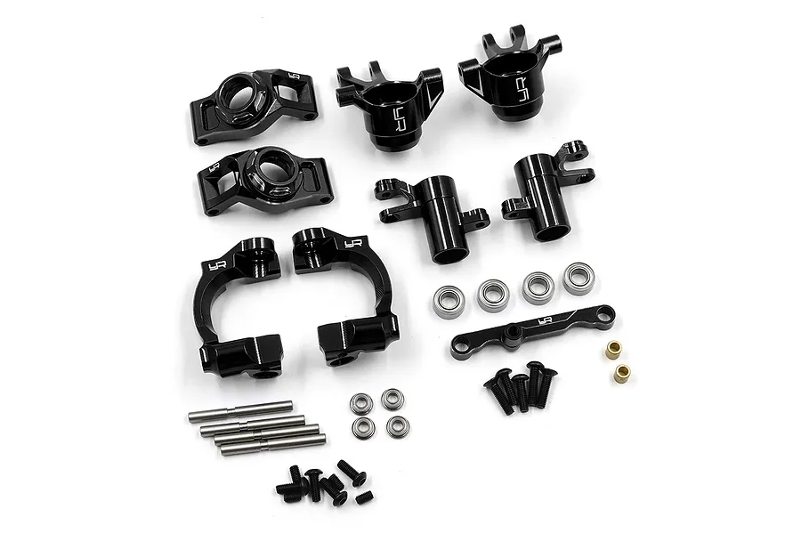 A set of black anodized aluminium RC car suspension and steering parts by Yeah Racing, including hubs, knuckles, bearings, screws, and pins.