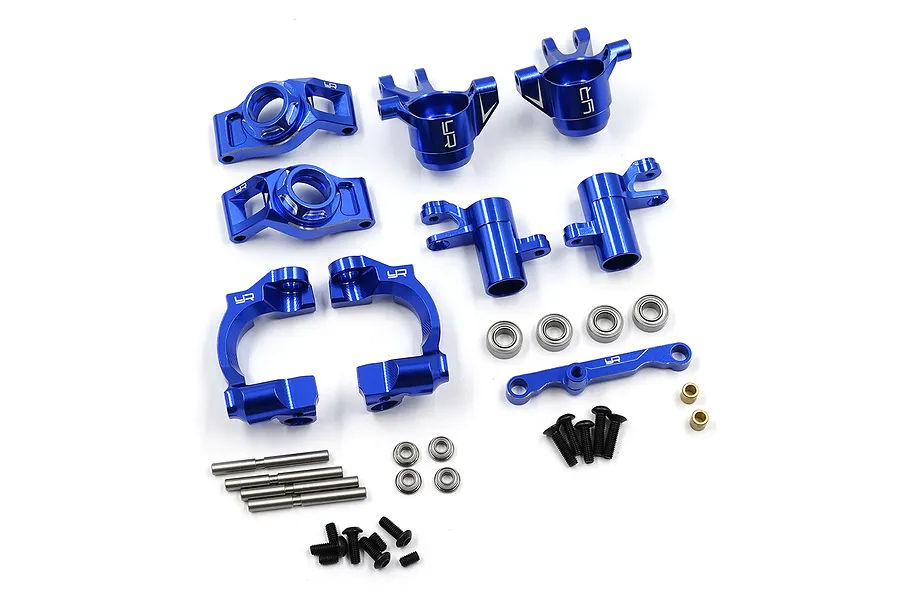 A set of dark blue anodized aluminium RC car suspension parts including steering knuckles, C-hubs, bearings, screws, and pins.