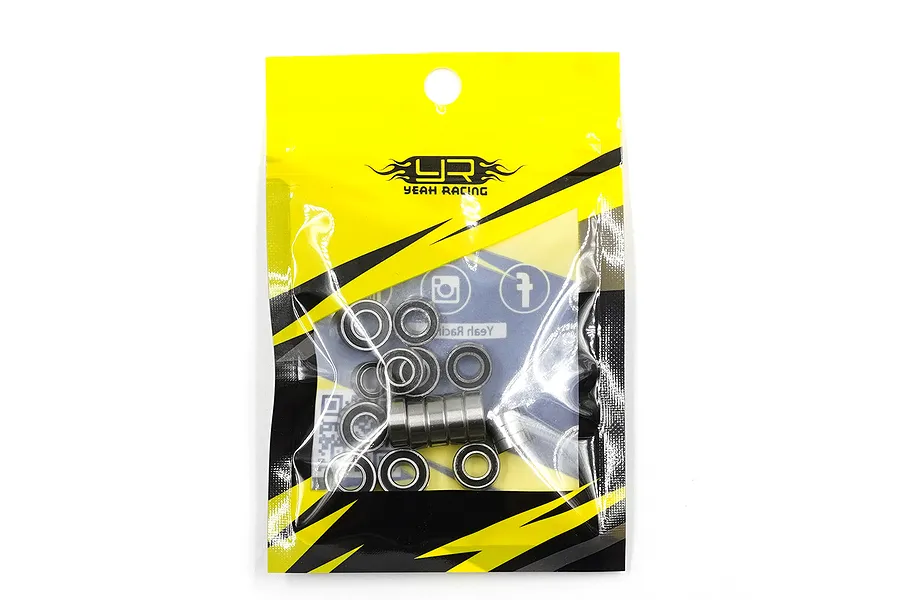 A sealed yellow and black Yeah Racing branded plastic bag containing a set of small metal ball bearings for RC vehicles.