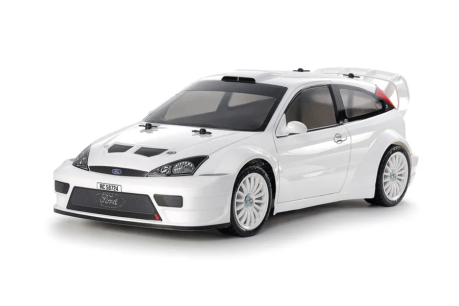 A studio shot of a white Tamiya 1/10 scale 2003 Ford Focus RS RC rally car model on a white background.