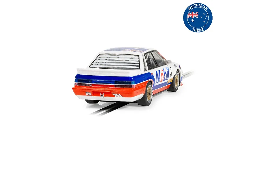 Rear three-quarter view of a white, blue, and orange Scalextric 1/32 scale Holden VL Commodore slot car with Mobil branding on a track.