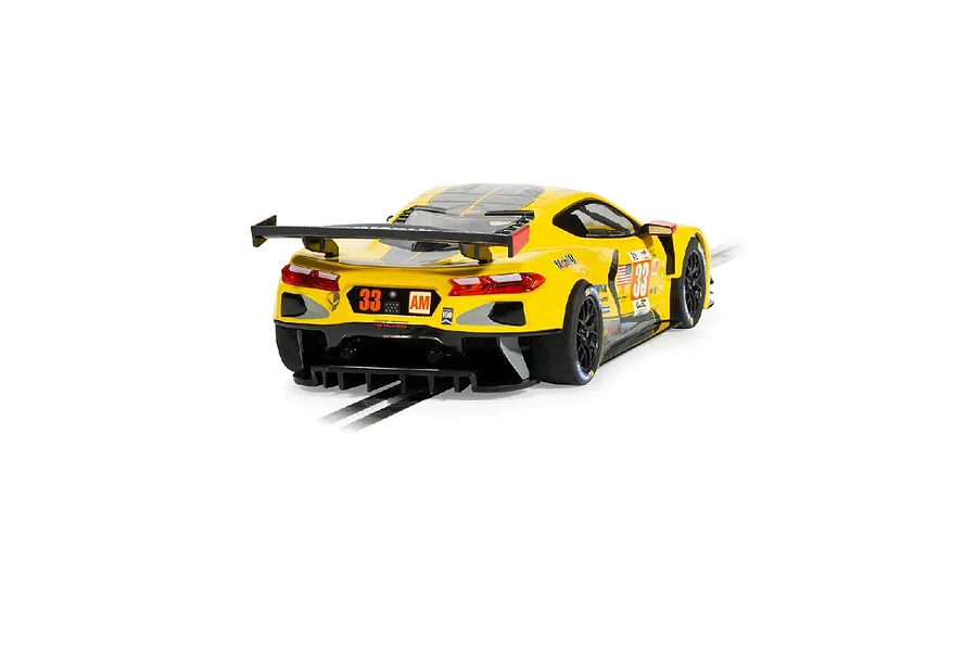 Rear three-quarter view of a yellow Scalextric 1/32 Chevrolet Corvette C8.R slot car with number 33 racing livery on a white background.