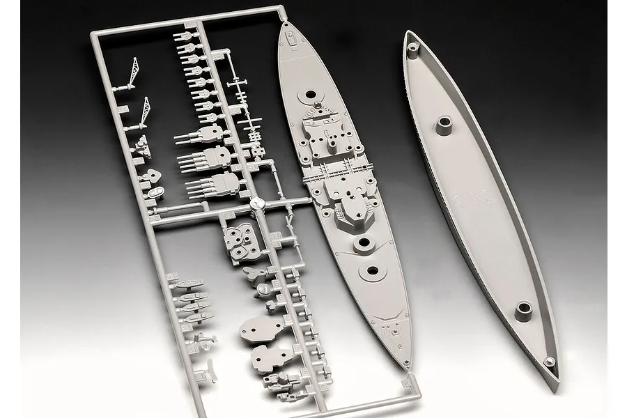 A grey plastic sprue containing parts for a 1/1200 scale battleship model kit, including the ship deck and hull pieces.