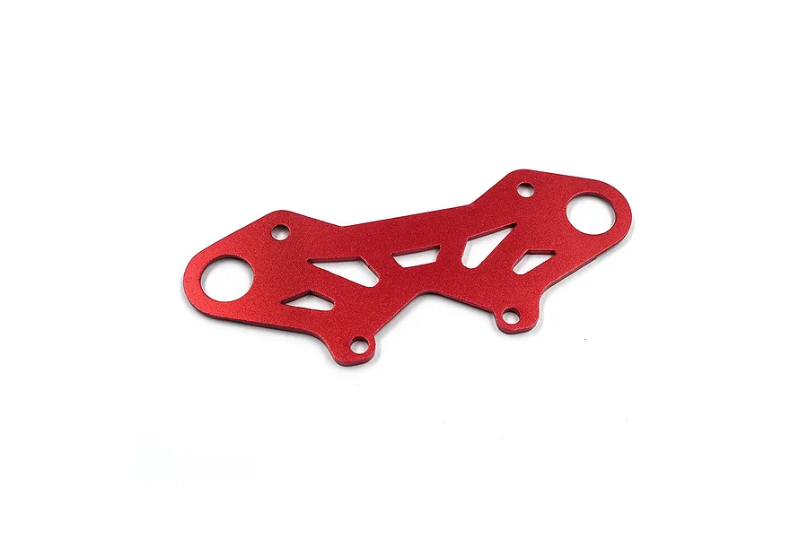 A red anodized aluminium bumper plate brace for an RC car, featuring a geometric cutout design and multiple mounting holes.