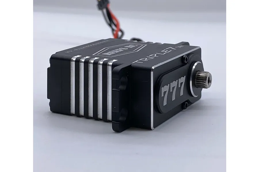 Reefs RC Triple 7 brushless metal geared servo in black with silver accents, shown from a side angle on a white background.