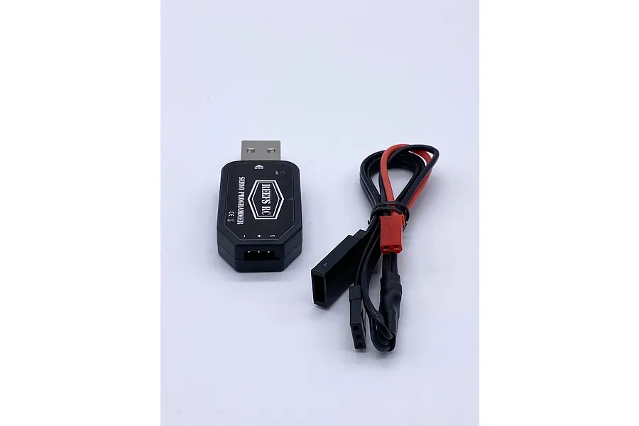 Reefs RC USB servo programmer device with a black plastic housing and an attached wiring harness featuring a JST connector.