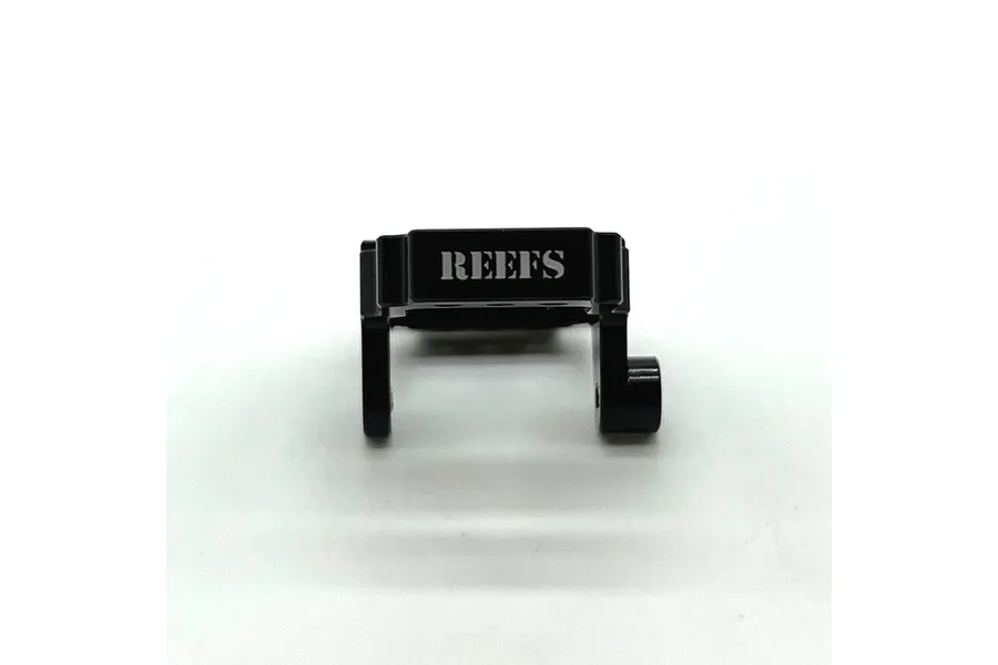 A black anodized aluminium servo mount for RC vehicles with the Reefs RC logo laser-etched on the front, set against a plain white background.