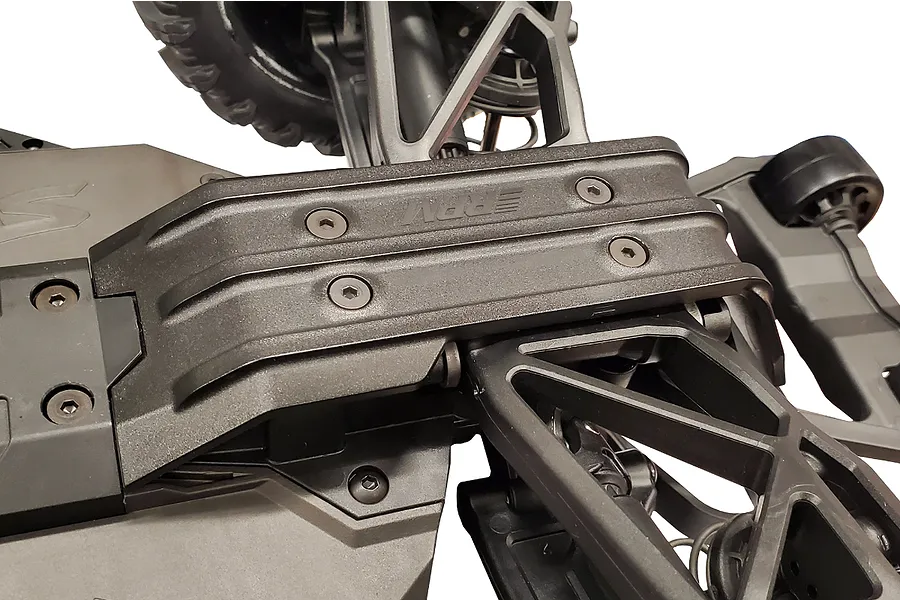 Close-up of an RPM black rear skid plate installed on an RC vehicle chassis, showing the brand logo and mounting screws.