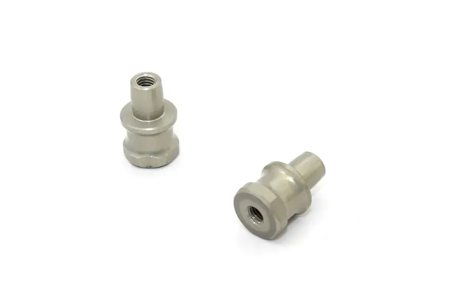 Two Kyosho short shock bushings made of metallic grey material, shown from different angles on a white background.