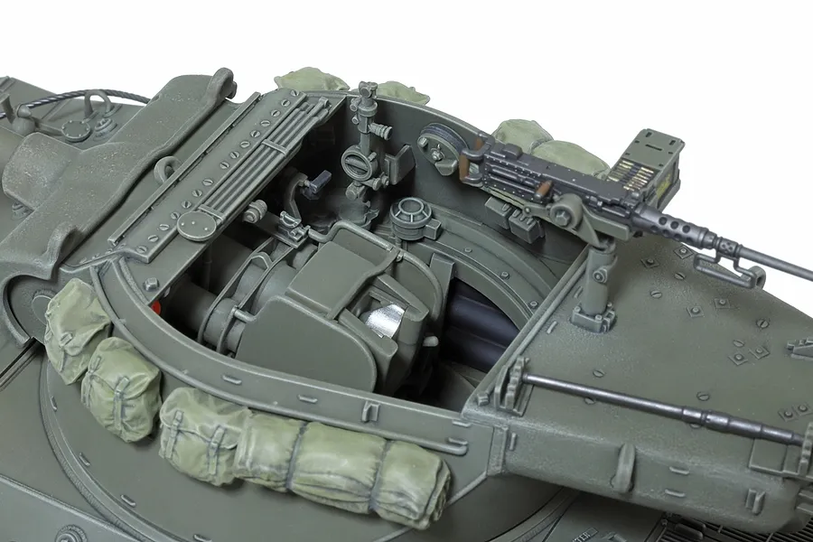 Close-up of the open turret interior of a Tamiya 1/35 scale M36 U.S. Tank Destroyer model kit, showing detailed gun breech and mounted machine gun.