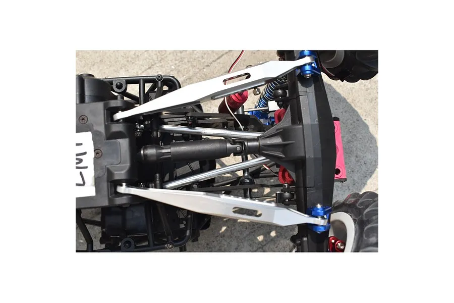 Top-down view of a silver GPM Racing lower link bar set installed on an RC vehicle chassis.
