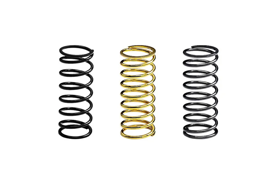 Three RC shock springs standing upright, two black and one gold, against a white background.