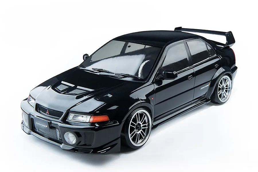 A black 1/10 scale MST RMX 2.5 Mitsubishi Evolution V RC drift car viewed from a high angle against a white background.