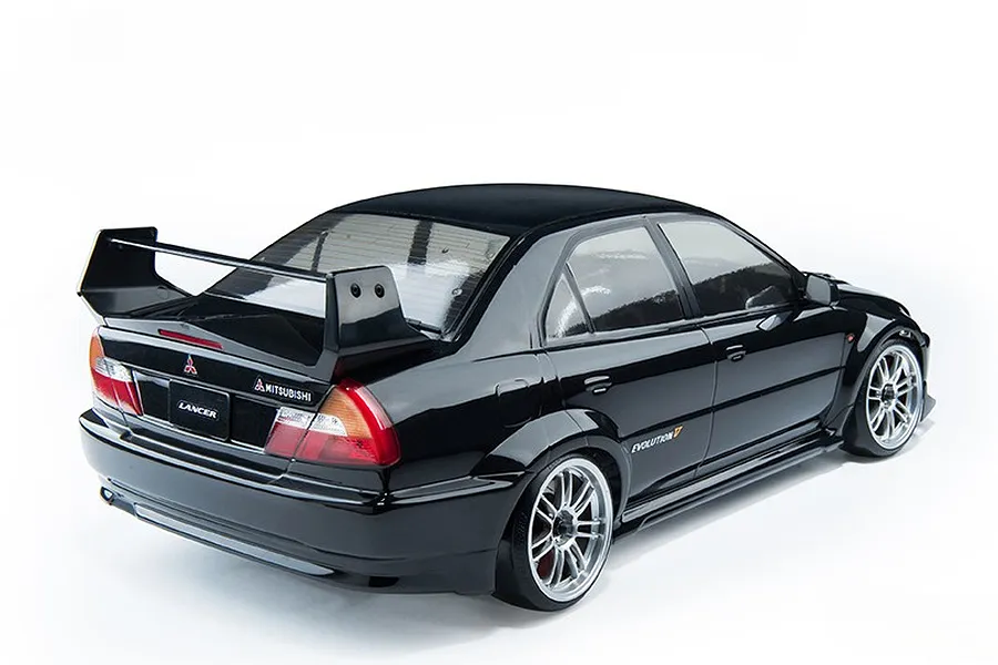 Rear three-quarter view of a black 1/10 scale MST Mitsubishi Lancer Evolution V RC drift car on a white background.