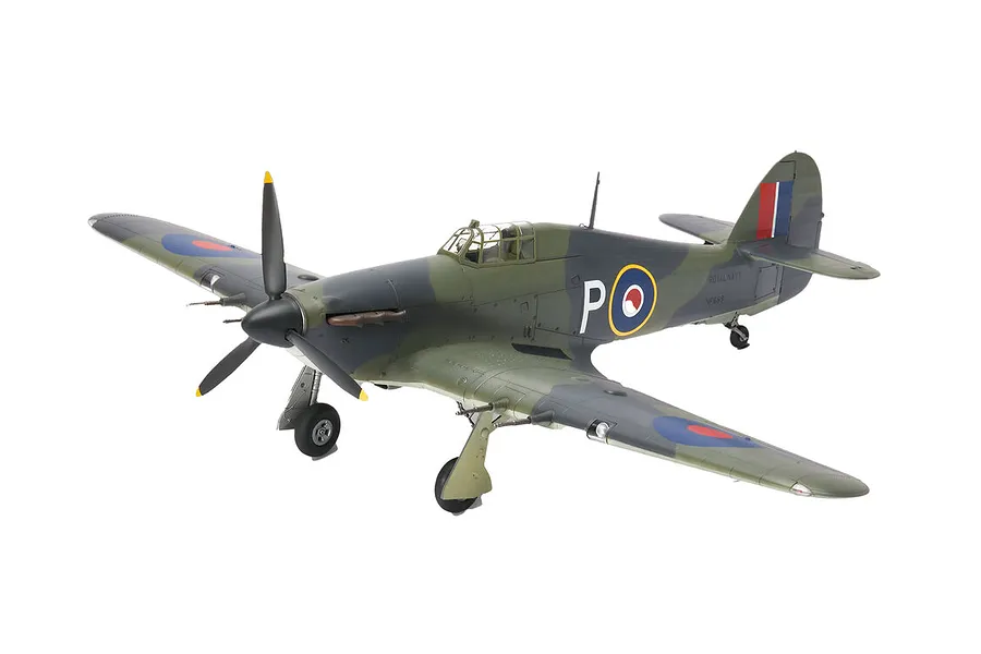 A completed 1/32 scale plastic model of a Hawker Sea Hurricane Mk.IIC fighter plane with camouflage paint and Royal Navy markings.