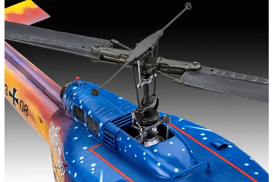 Close-up of the rotor assembly and fuselage of a painted Revell Bell UH-1D Goodbye Huey model helicopter.